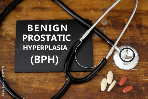 BENIGN PROSTATIC HYPERPLASIA (BPH) or prostate enlargement. Stethoscope and medication on wooden table. photo