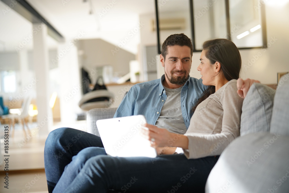 Couple relaxing in sofa and connected with digital tablet Couple relaxing in sofa and connected with digital tablet