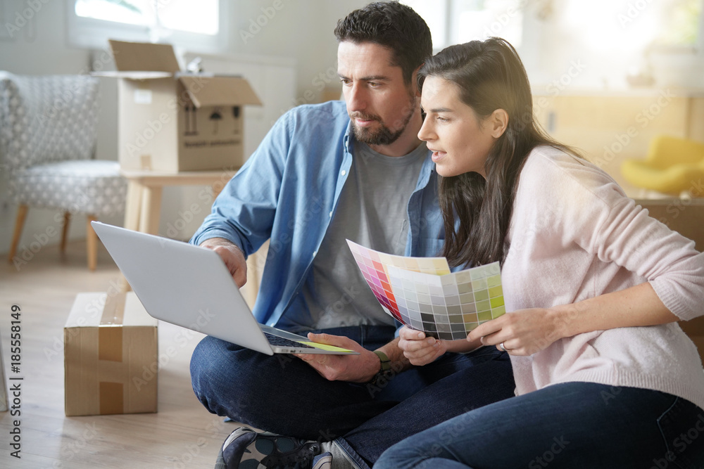 Couple choosing paint colours to reform house Couple choosing paint colours to reform house