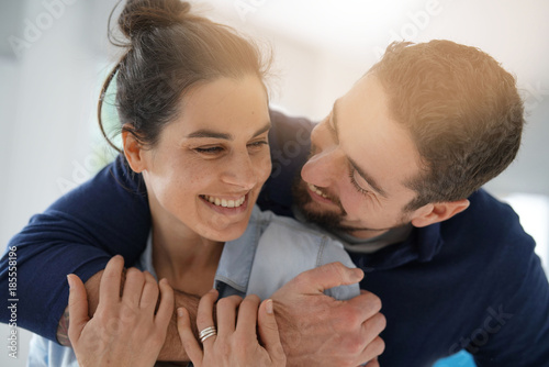 Obraz na plátne Cheerful romantic couple of lovers cuddling