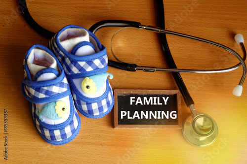 Family planning concept with stethoscope and cute blue baby shoes