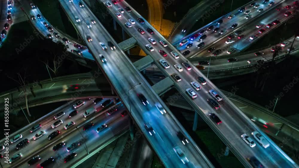 Cinematic urban aerial time lapse of city infrastructure including freeways, interstates, roads, streets with traffic at rush hour during the evening. Cinematic urban aerial time lapse of city infrastructure including freeways, interstates, roads, streets with traffic at rush hour during the evening.