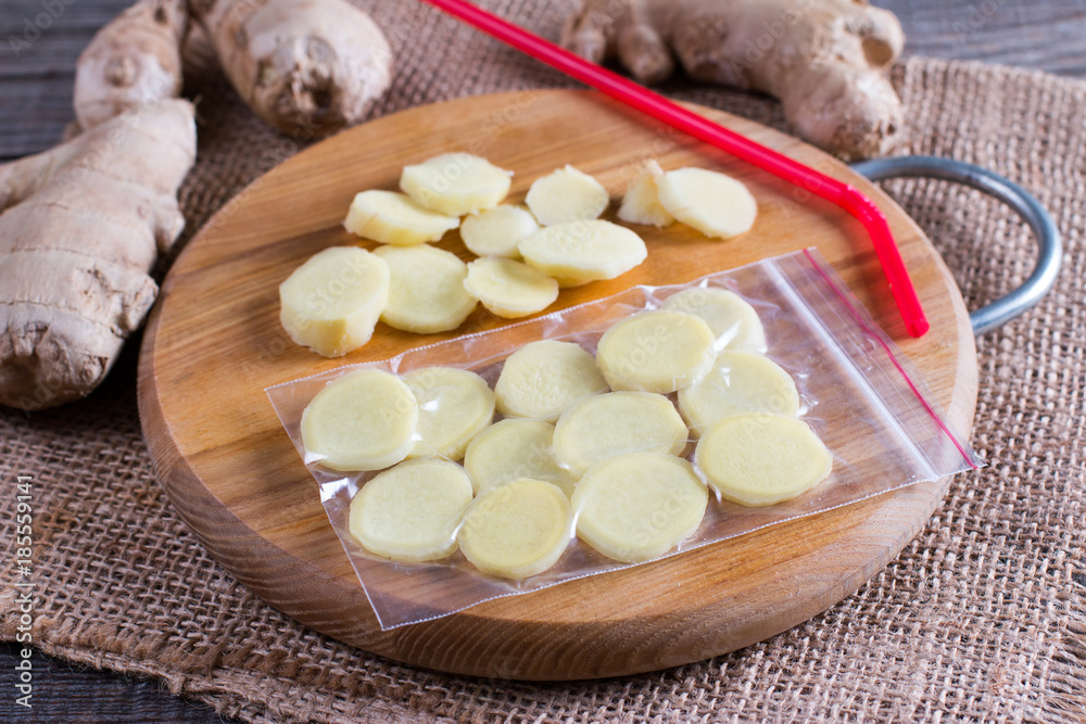 Cutting board with ginger root sliced Cutting board with ginger root sliced