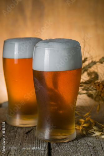 Beer in frosty mugs on rustic background