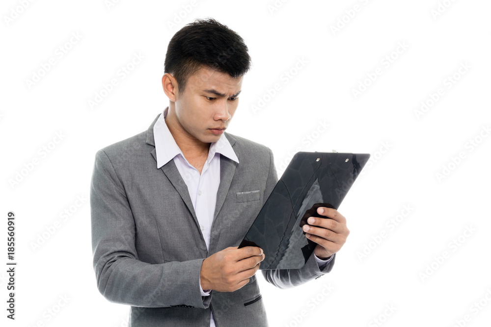 Portrait of a young business man reading annual report. Isolated on white background Portrait of a young business man reading annual report. Isolated on white background