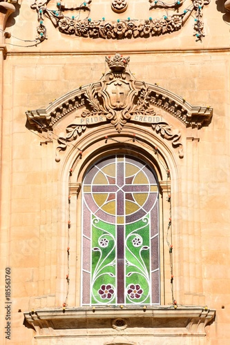 Ornate stained glass window on the front of Naxxar Parish church, Naxxar, Malta. photo