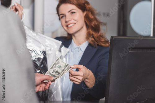 dry cleaning manageress taking cash for order