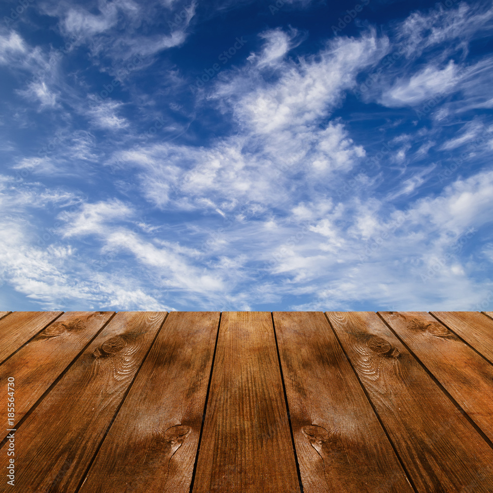 Wood platform and blue sky with clouds