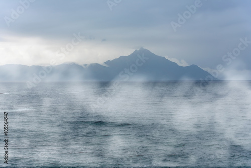 Mysterious island over ocean during foggy morning   © Savvapanf Photo ©