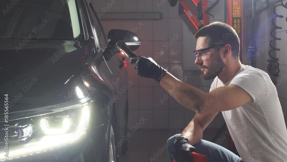 Process of checking quality of polishing of the car body. Process of checking quality of polishing of the car body.