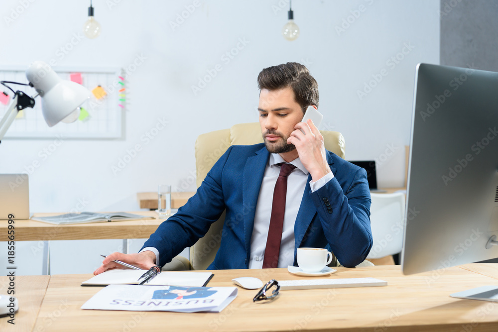 focused businessman talking by smartphone in office focused businessman talking by smartphone in office