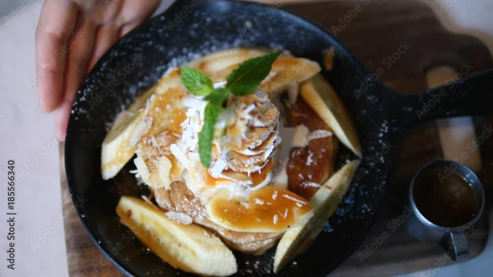 Top View Of Pancakes with Banana, Caramel And Whipped Cream On Table. Closeup. 4K. Top View Of Pancakes with Banana, Caramel And Whipped Cream On Table. Closeup. 4K.
