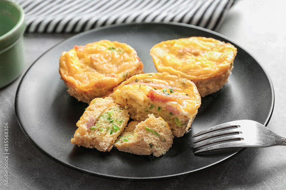 Plate with tasty egg muffins on table, closeup