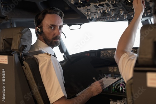 Pilot and copilot flying an airplane photo