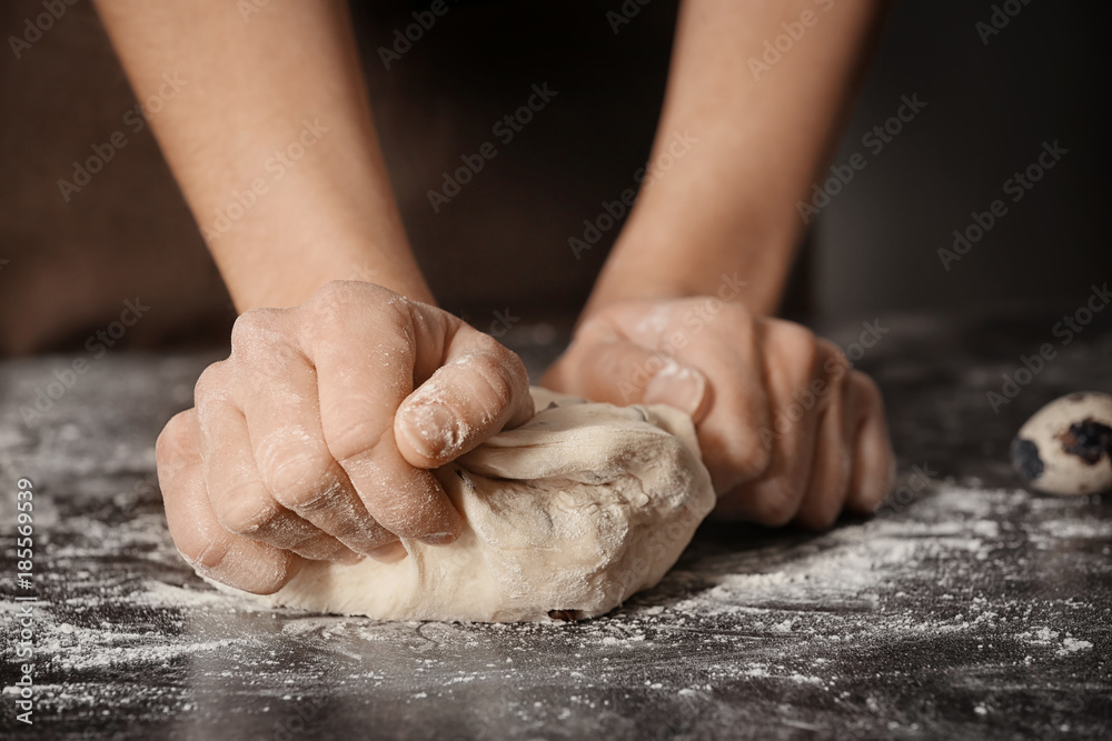 Woman kneading dough on table Woman kneading dough on table