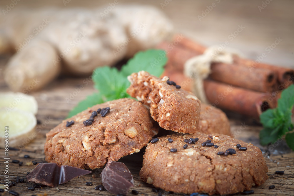 Fototapeta premium Ginger cookies with chocolate and nuts on rustic wooden table