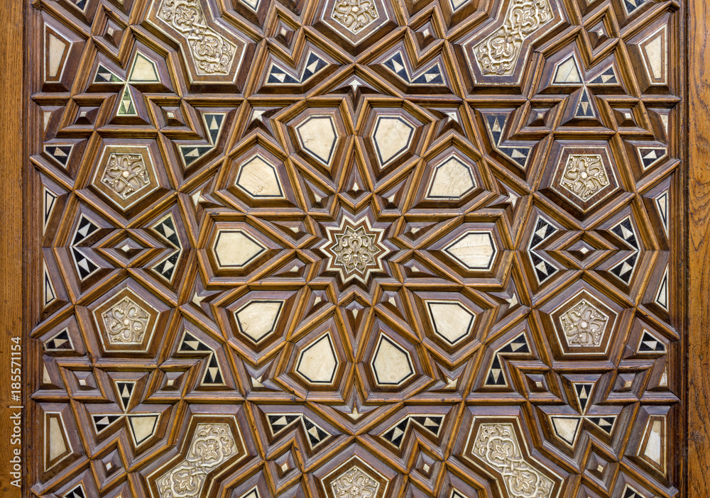 Closeup of arabesque ornaments of an old aged decorated wooden door, Old Cairo, Egypt