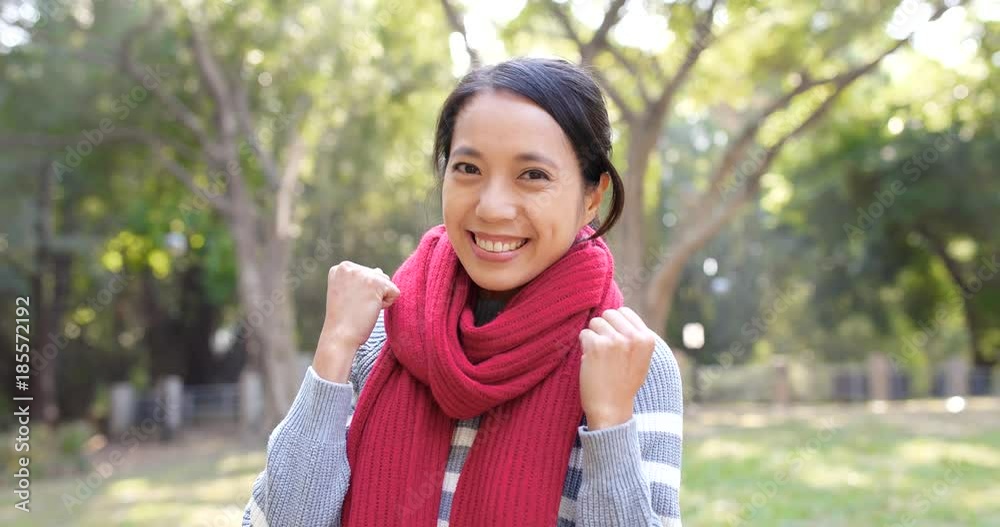 Excited happy woman cheer up in the city park over sunlight flare Excited happy woman cheer up in the city park over sunlight flare