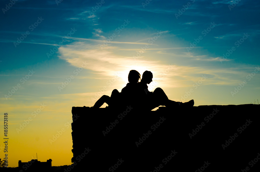 silhouette of lovers on the background of the sky