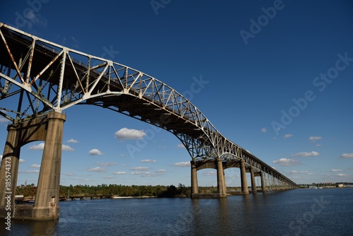 Vászonkép Low angle view of the Calcasieu River Bridge against blue skies and clouds, Lake
