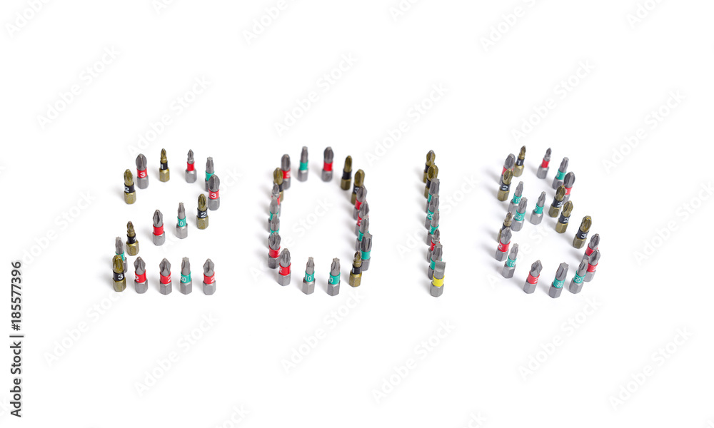 Set of heads for screwdriver (bits) in New year order 2018. Tools collection close up, isolated white background.