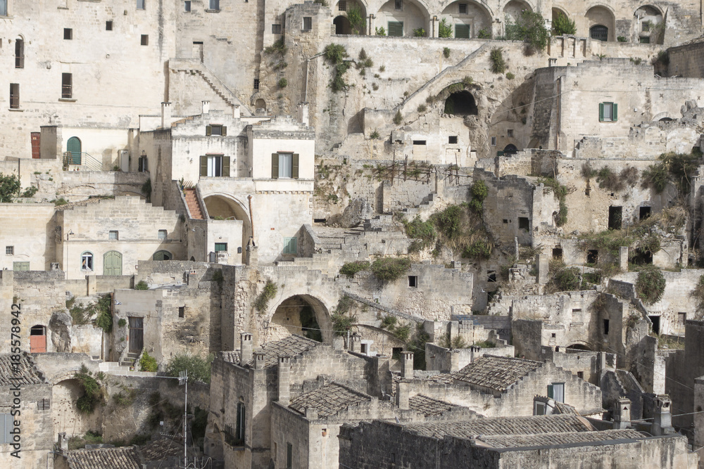 Ancient architecture of Sicilian city of Matera with the dense houses. Panoramic view of the borough, houses, windows, arches, terraces