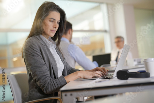 Businesswoman working in office on laptop computer