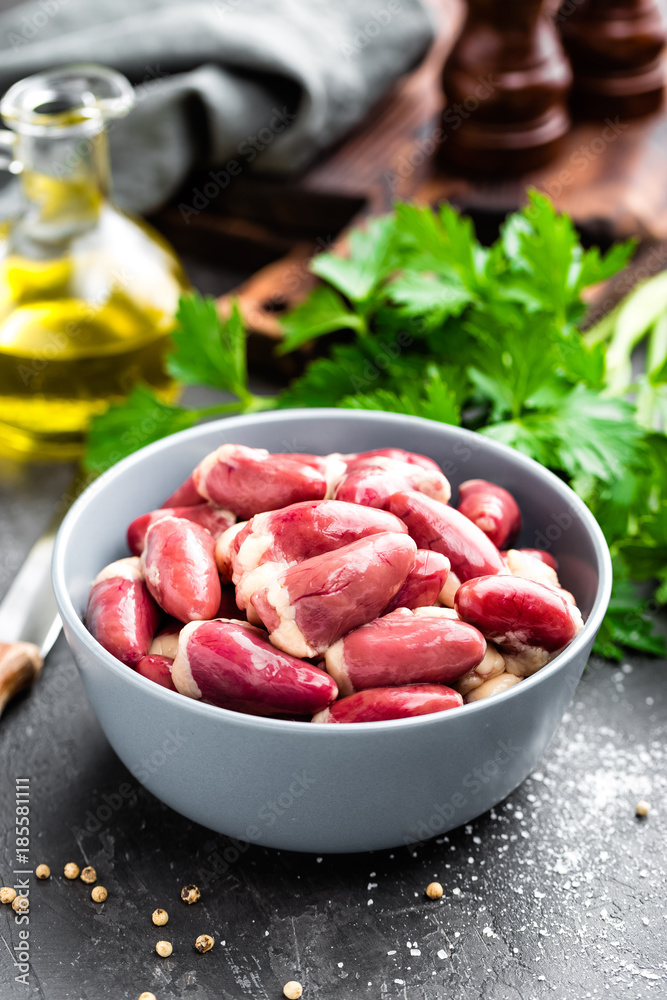 Fresh raw chicken hearts on dark background Fresh raw chicken hearts on dark background