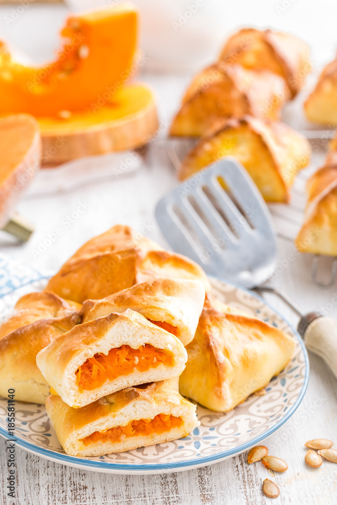 Delicious homemade baking. Patties with fresh pumpkin on white background, closeup Delicious homemade baking. Patties with fresh pumpkin on white background, closeup