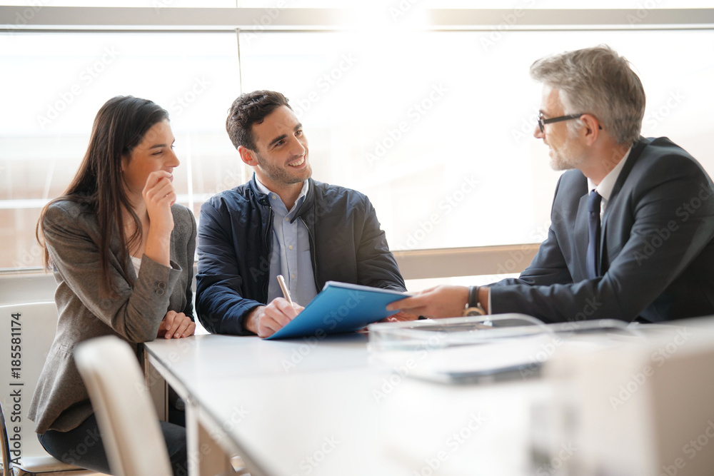 Young couple meeting financial advisor for home investment Young couple meeting financial advisor for home investment