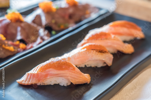 Set of Salmon aburi sushi with saikyo sauce on plate