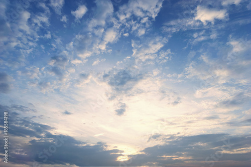 Sky blue and orange light of the sun through the clouds in the sky