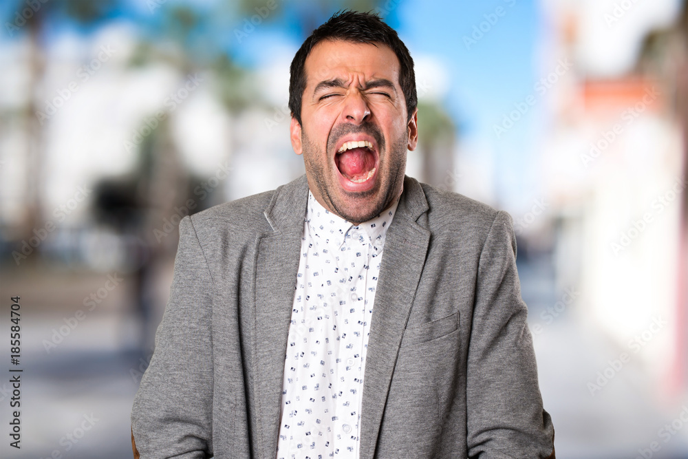 Fototapeta premium Handsome man shouting on unfocused background