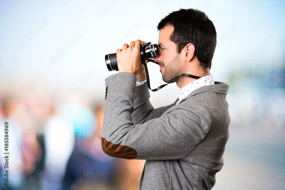 Handsome man with binoculars on unfocused background Handsome man with binoculars on unfocused background