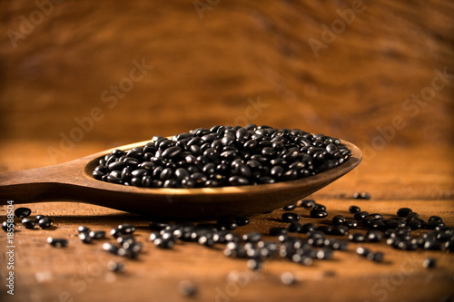 black beans on wood background