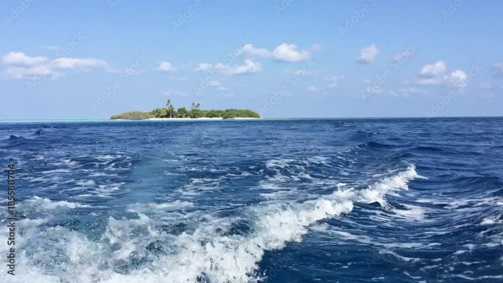 Leaving a tropical island with boat