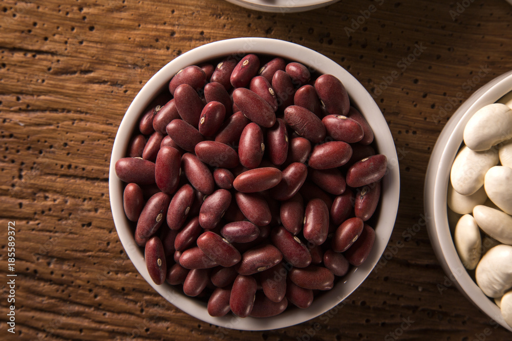 Assorted beans in bowls on wood background Assorted beans in bowls on wood background