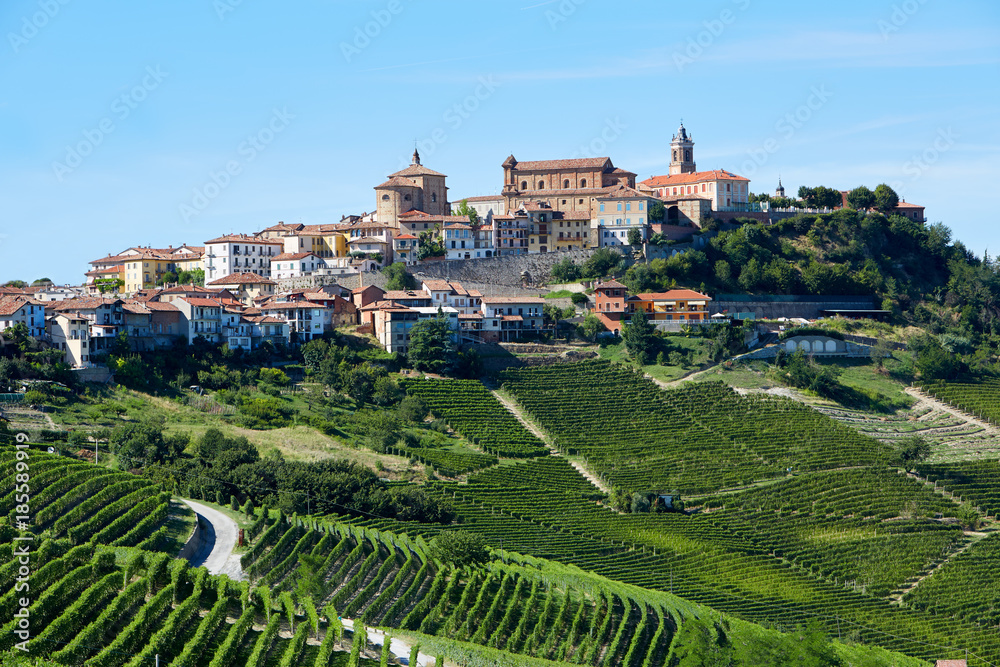 La Morra town with vineyards in Piedmont, Langhe hills in Italy, blue sky