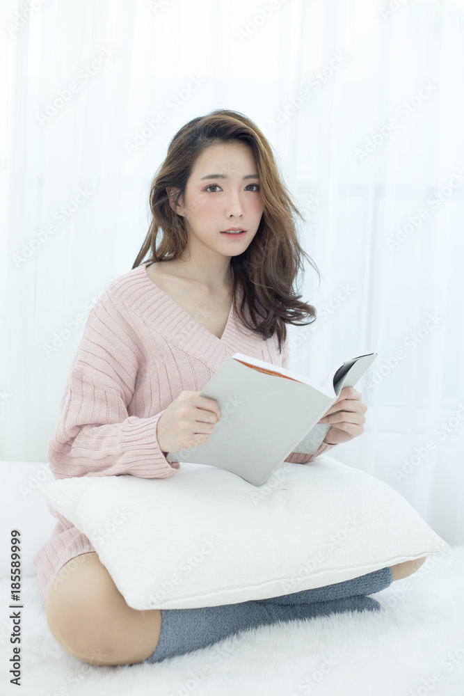 Attractive Asian Woman Holding book with happy emotion, People lifestyle concept. Attractive Asian Woman Holding book with happy emotion, People lifestyle concept.