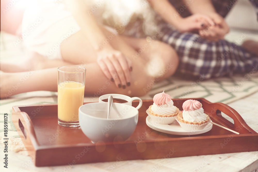 Romantic vibes. Two beautiful loving people having a great morning and eating they morning meal while spending the weekend at home together Romantic vibes. Two beautiful loving people having a great morning and eating they morning meal while spending the weekend at home together