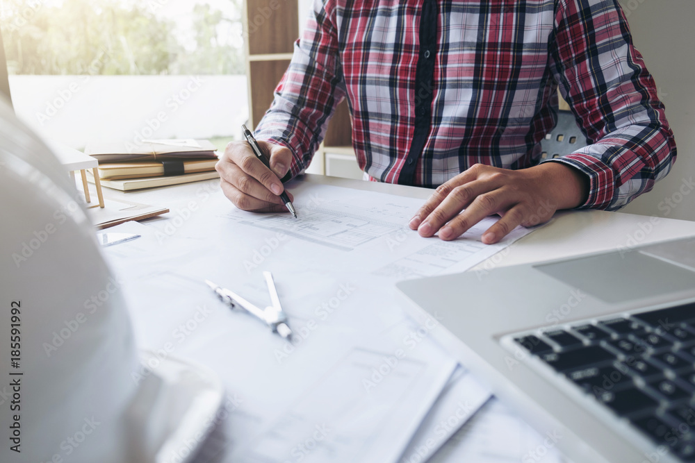 Architect working on blueprint, Engineer working with engineering tools for architectural project on workplace Architect working on blueprint, Engineer working with engineering tools for architectural project on workplace