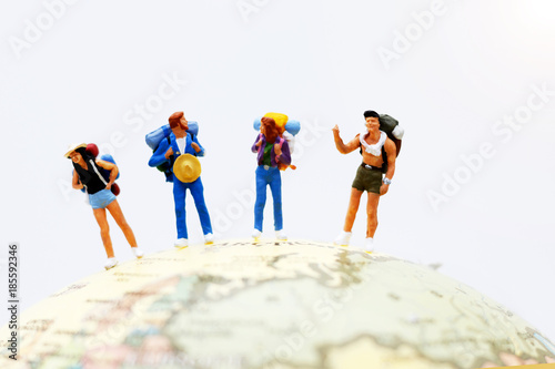 Miniature people, backpackers on the globe walking to destination. travel and business concept..