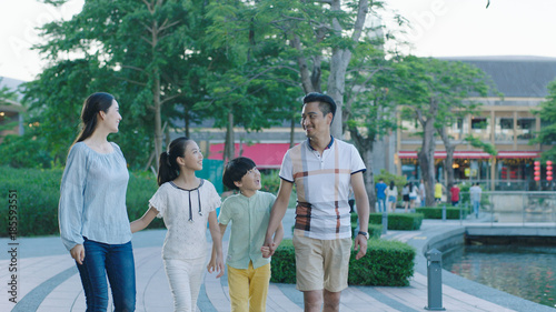 Photography Asian family walking together on promenade, excited when looking at each other