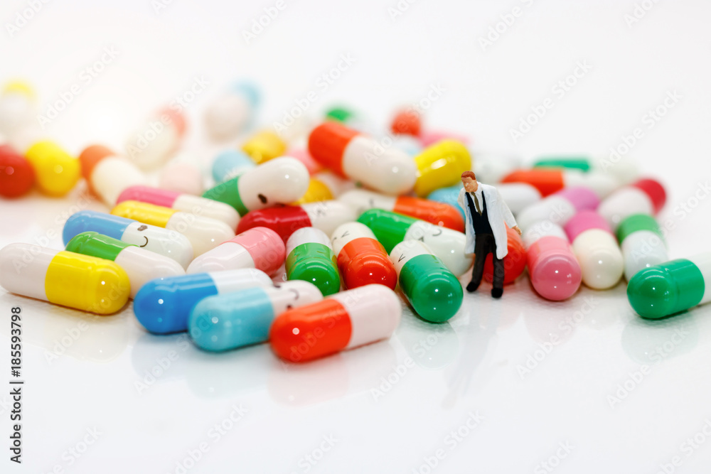 miniature people : doctor with drug using as background medical concept miniature people : doctor with drug using as background medical concept