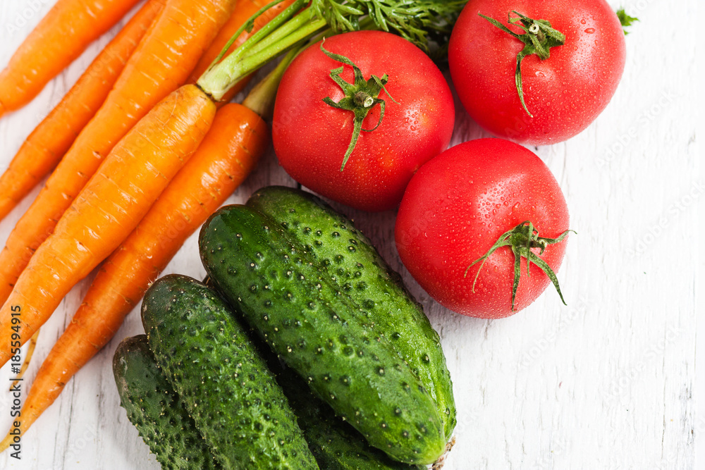 Ripe carrots, tomatoes, cucumbers in the fruit and vegetable market
