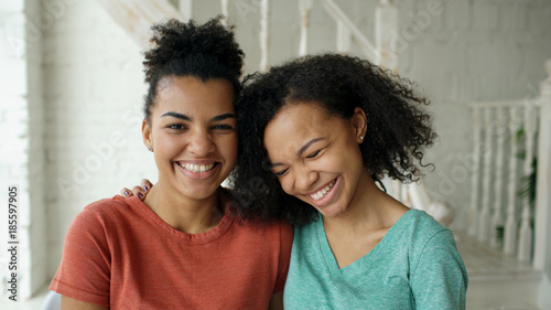 Fotografie Portrait of two beautiful african american girls laughing and looking into camer