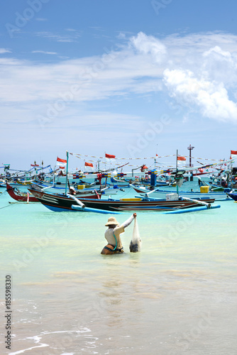 Travel destinations, island culture. Fisherman in the ocean, Bali, Indonesia.