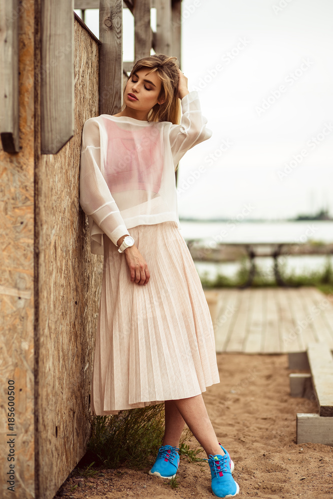 fashion portrait of blonde young woman in designer clothes in a summer day fashion portrait of blonde young woman in designer clothes in a summer day