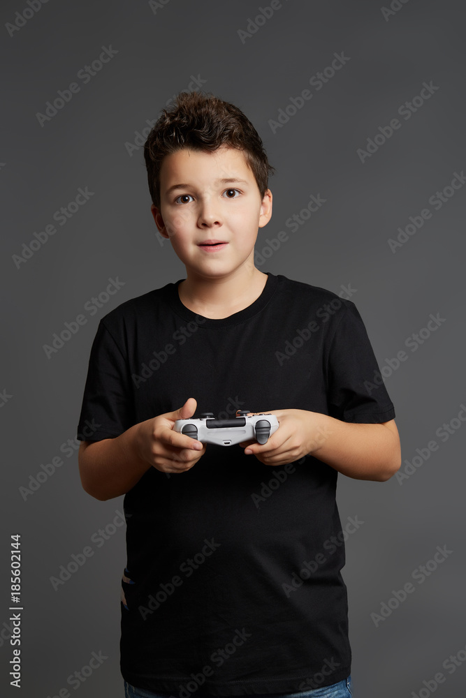 A cute boy in a black T-shirt and a white joystick A cute boy in a black T-shirt and a white joystick