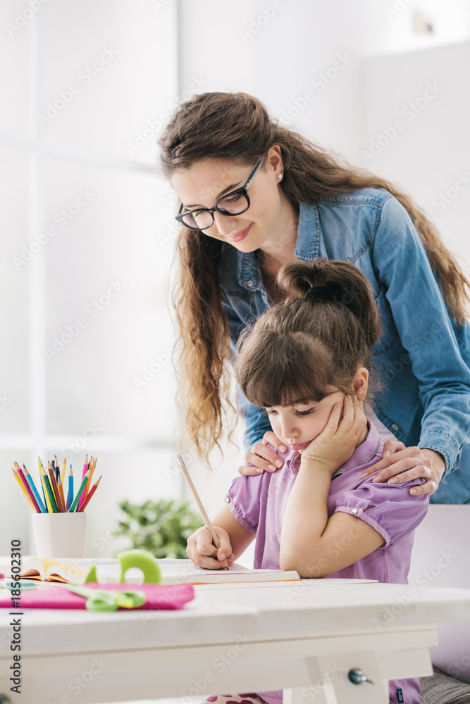 Mother and child doing homework together Mother and child doing homework together